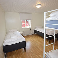 Schlafraum mit Etagenbett und 2 Einzelbetten im Rorbu 3+.