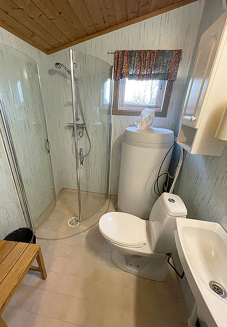 Blick ins Badezimmer von Haus 6 mit Dusche und WC.