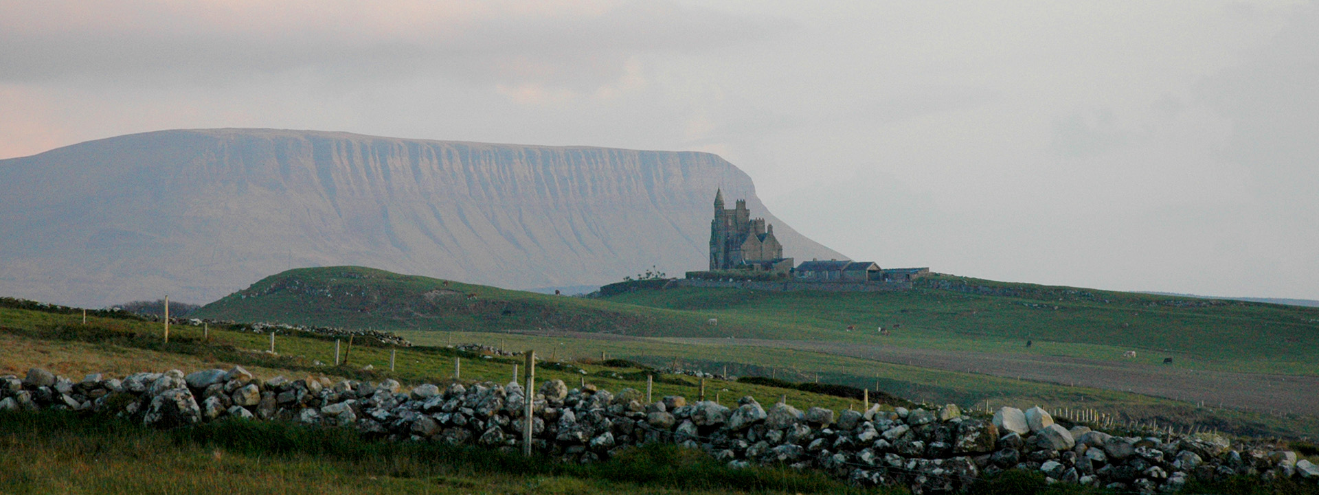 Eine Burg steht in der malerischen Landschaft der irischen Küste.